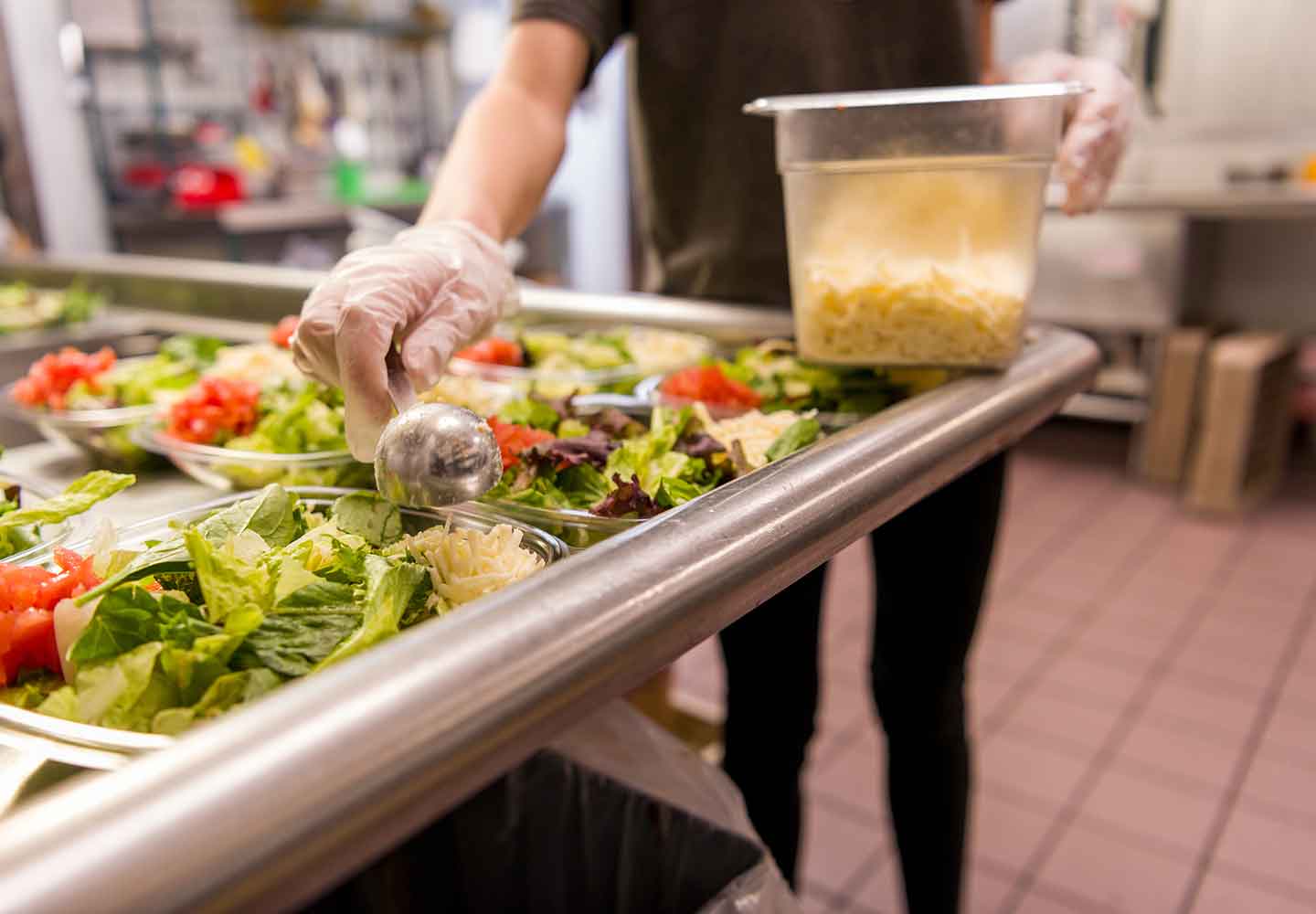 Wendy's crew member prepping salads