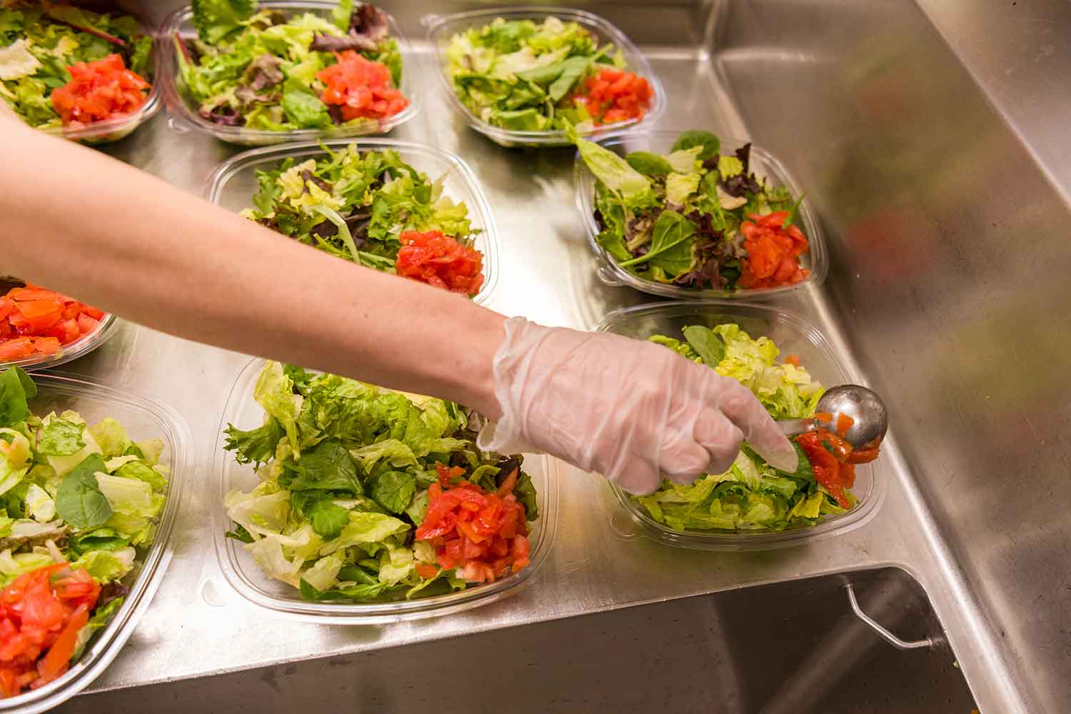 Wendy's crew member prepping salads