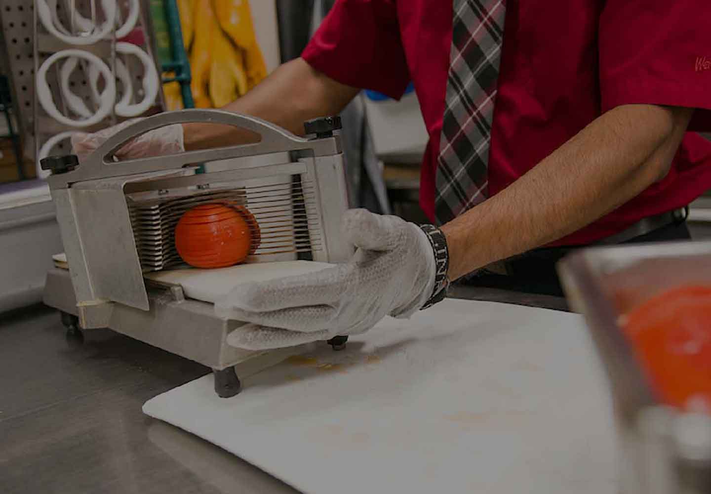 Wendy's crew member slicing fresh tomatoes