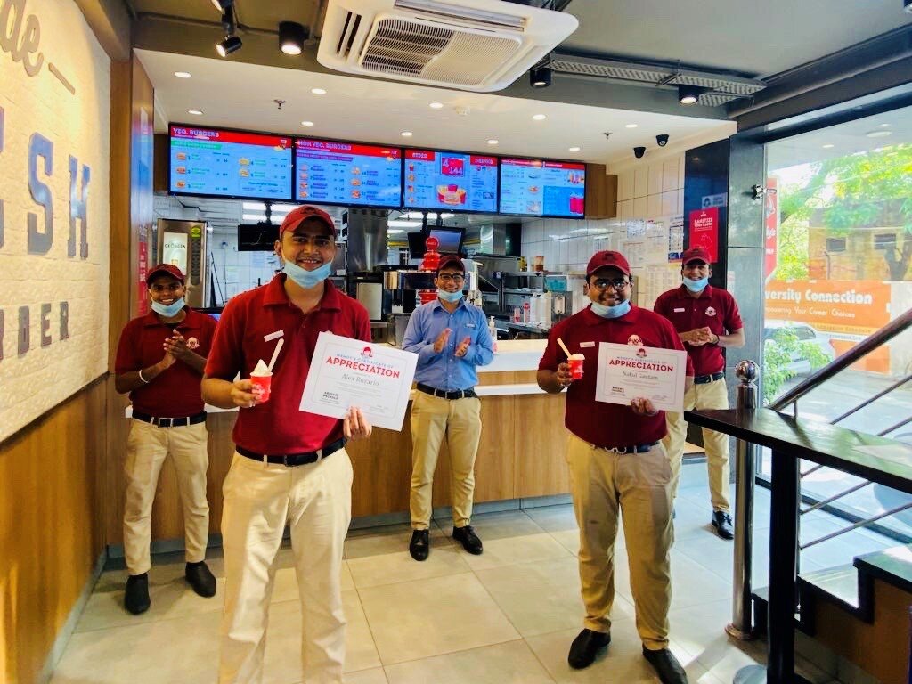 crew holding awards and frosties