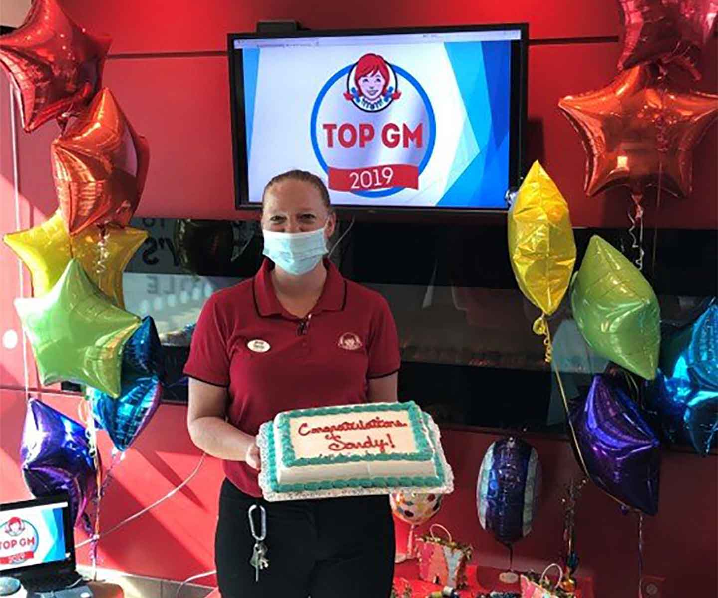 Wendy's Top GM celebrating with cake