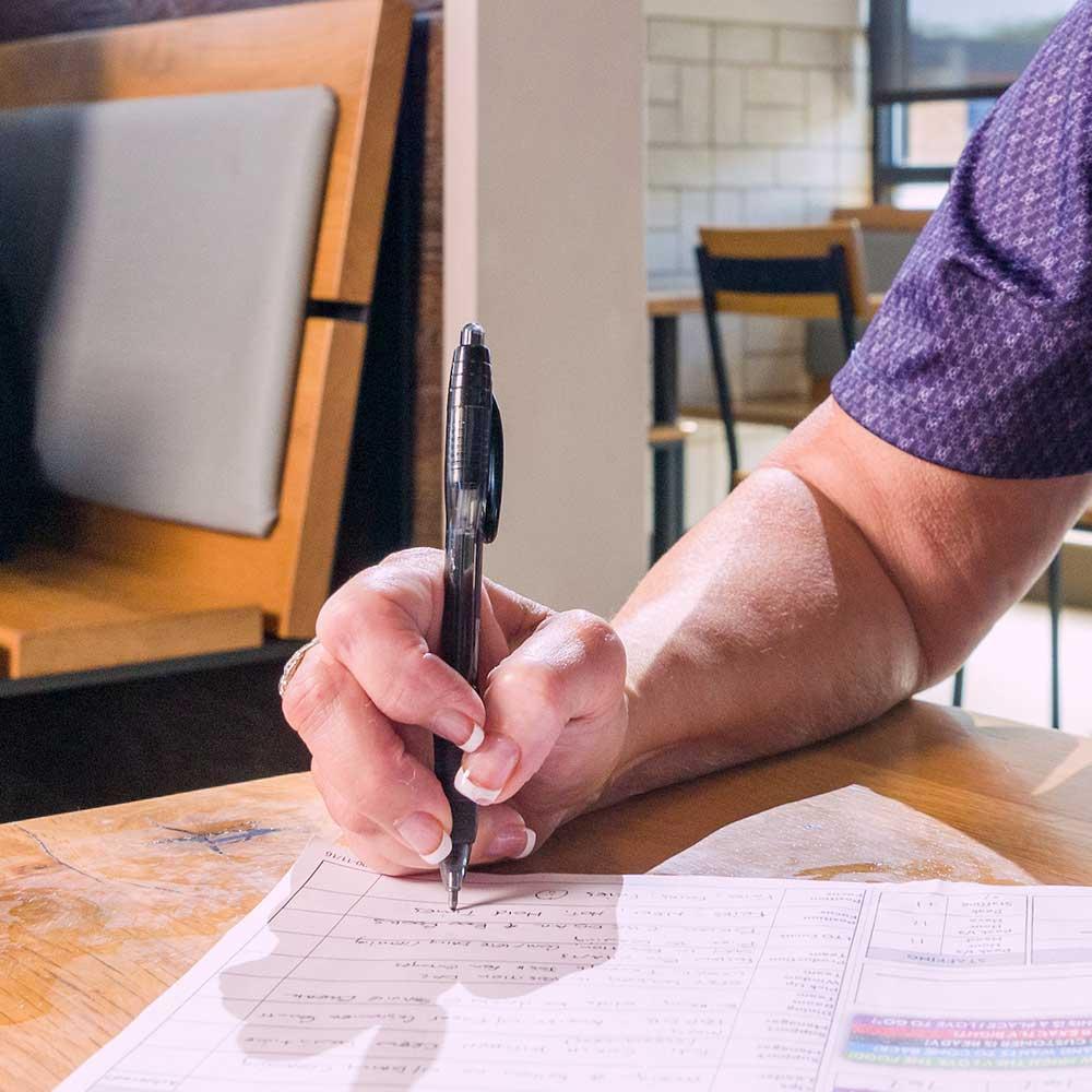 hand with pen filling out application