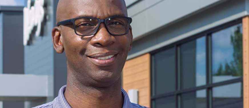 Smiling man in front of wendy's store
