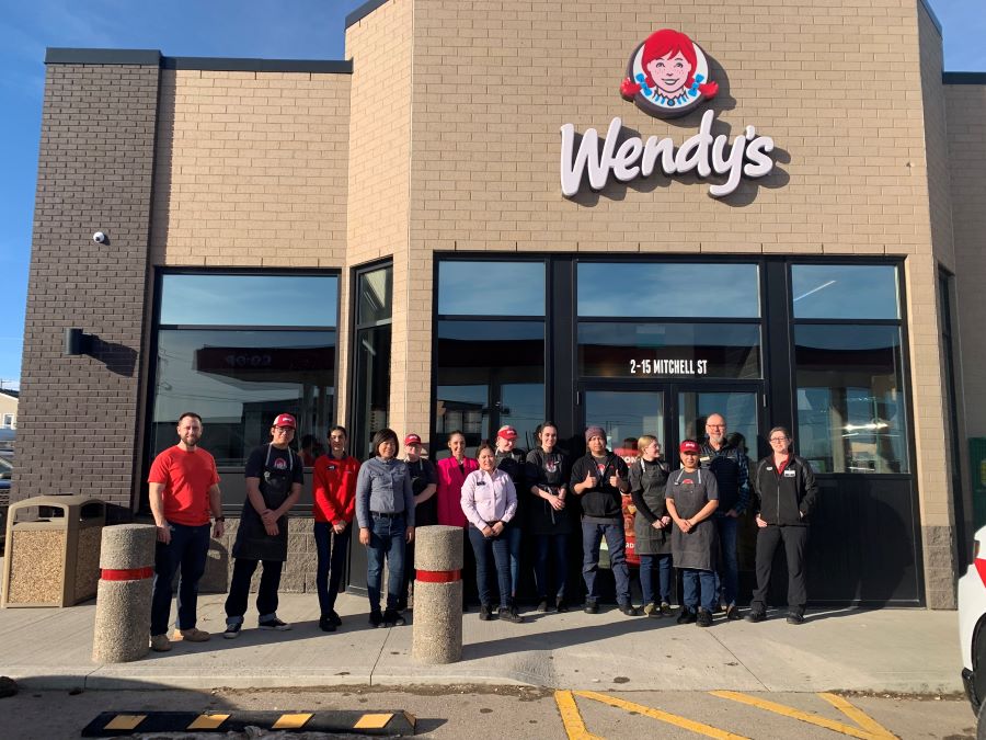 Wendy's team in Canada stands outside Wendy's restaurant conversion