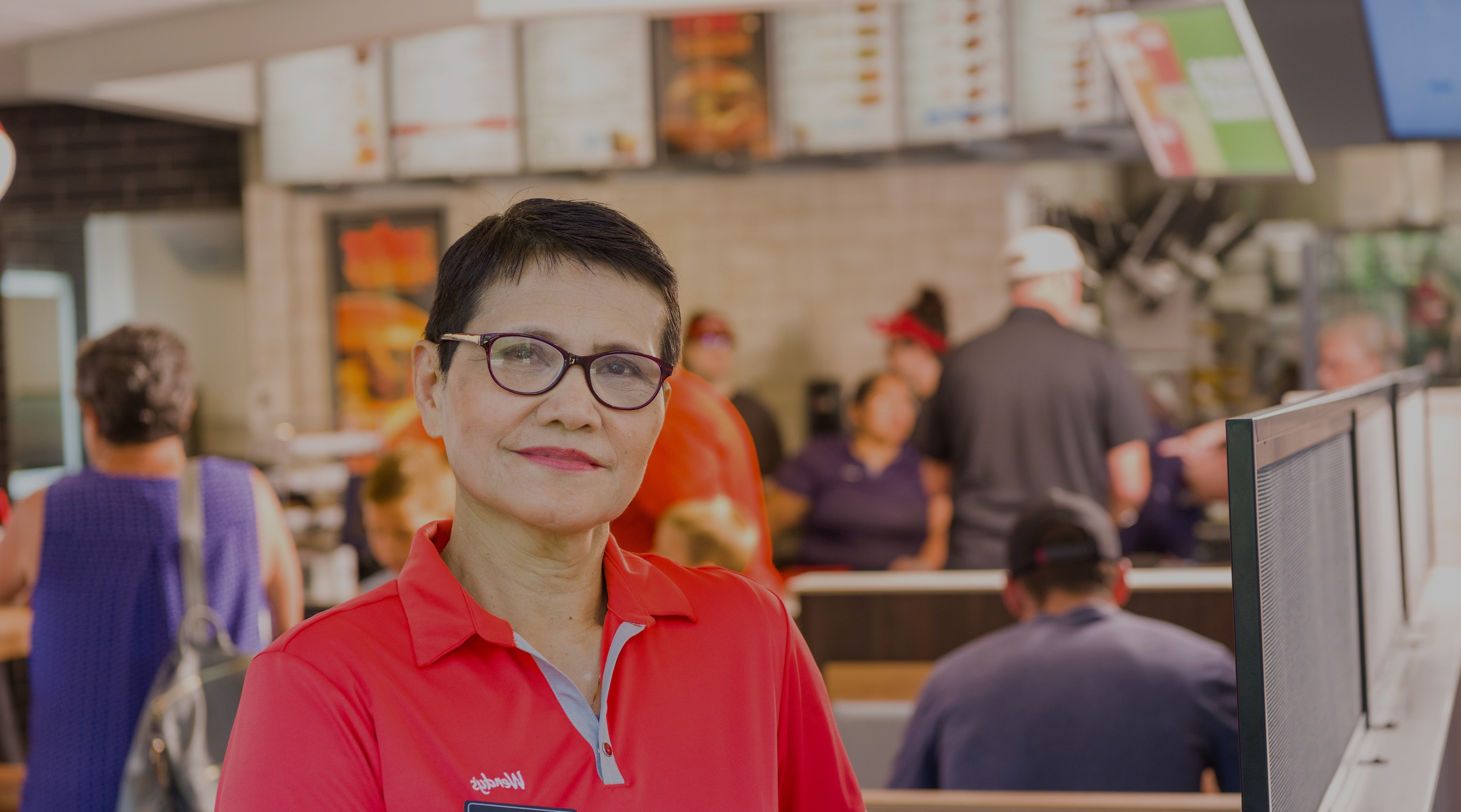 Wendy's Employee smiling at register