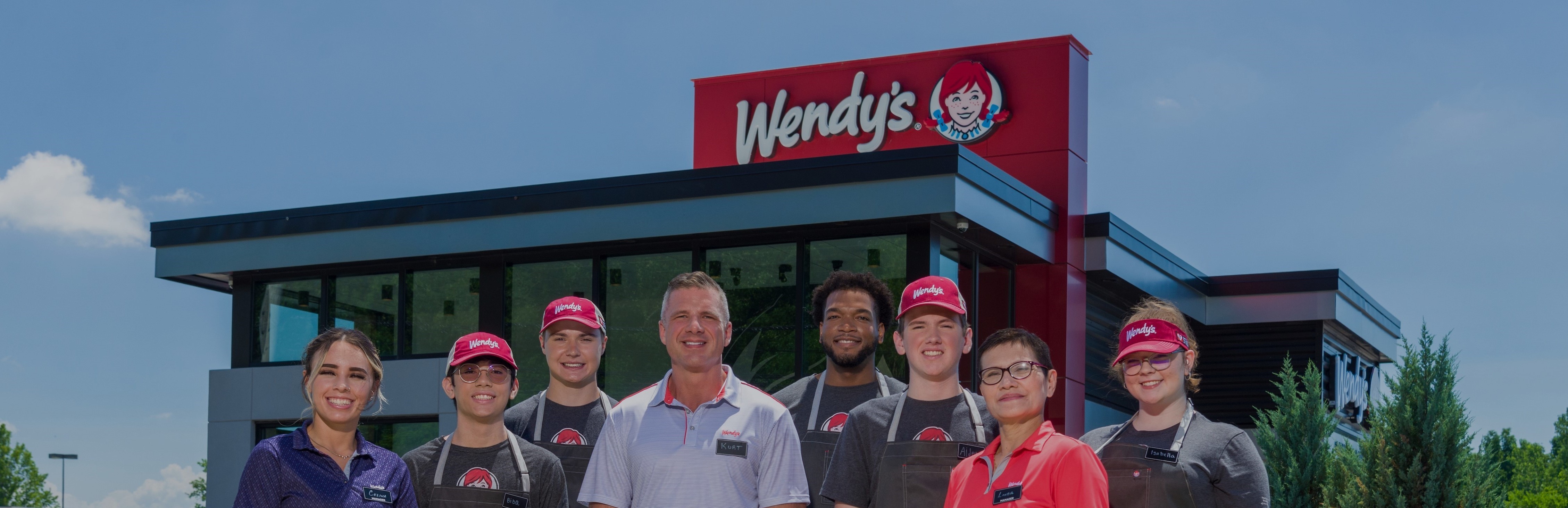Wendy's crew in front of restaurant