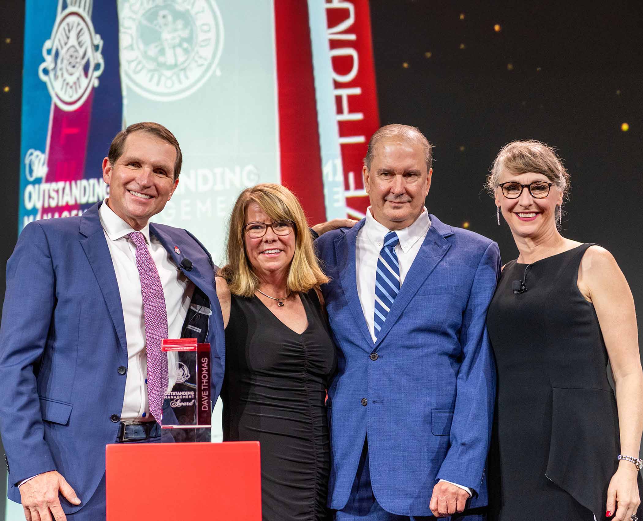 Wendy's employees accept an award on stage