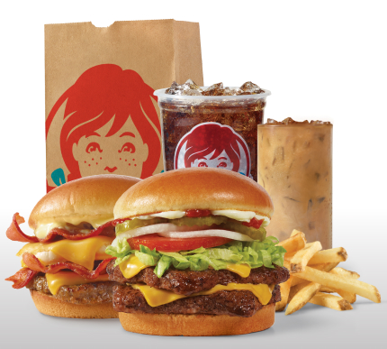 Get Wendy's Delivered: Breakfast Baconator® combo with seasoned potatoes and Frosty-ccino®, and Dave's Double® combo with fries and soft drink next to a Wendy's bag