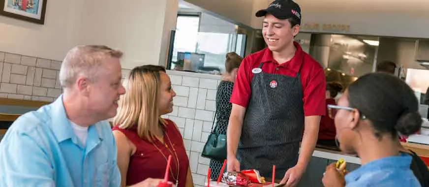 Wendy's crew member talking to Wendy's customers