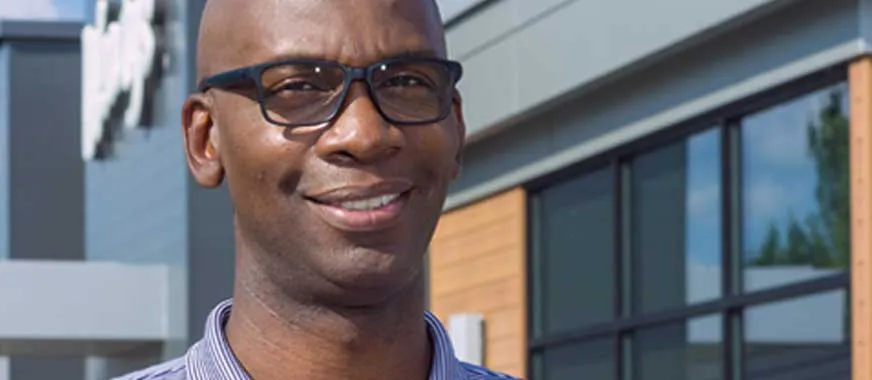Smiling man in front of wendy's store