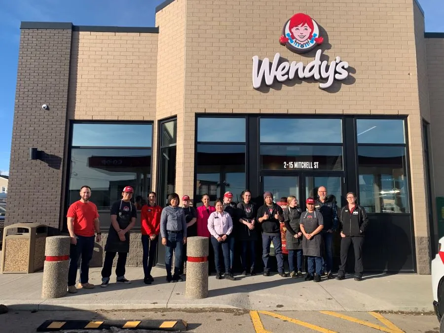 Wendy's team in Canada stands outside Wendy's restaurant conversion